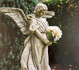 A statue of an angel holding flowers