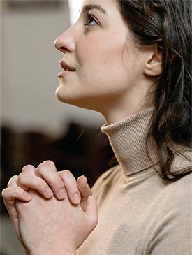 Woman with hands clasped