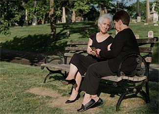 Two women on a cemetery bench