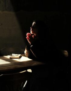 Woman Praying In Darkness
