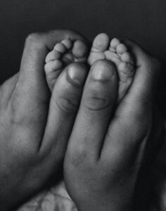 Hands Embracing Infant Feet