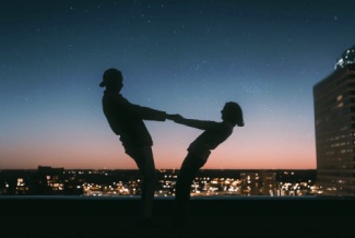 Silhouettes Holding Hands