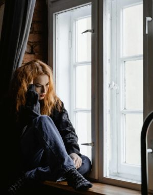Woman Sitting At Window