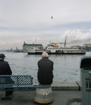 Man Sitting On Pier