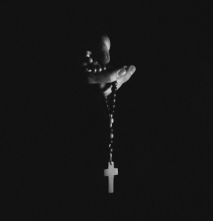 Hands Holding Rosary Beads